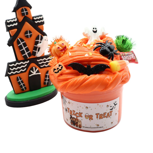 Halloween-themed toy set with a haunted house and candy bucket on a white background