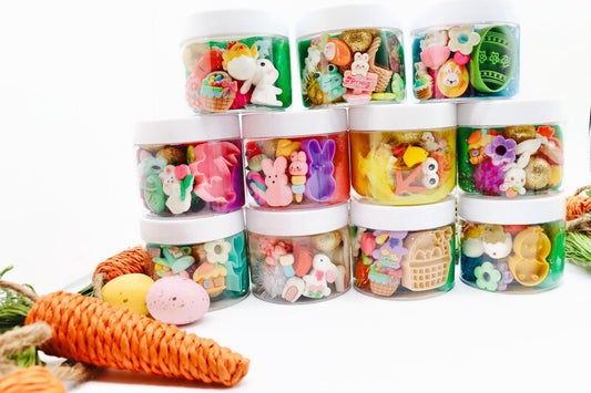 Assorted colorful toy containers with small figurines on a white background